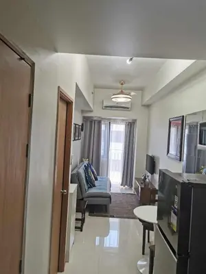a living room with a couch and a table at Moa SHORE 3 TOWER 2 RESIDENCE in Manila