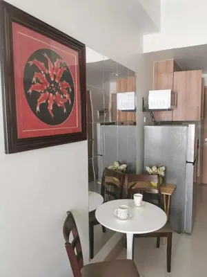 a kitchen and dining room with a table and a refrigerator at Moa SHORE 3 TOWER 2 RESIDENCE in Manila