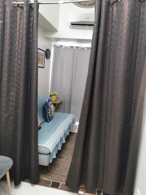 a room with curtains and a bench in a room at Mao shore 3 residence tower 2 in Manila