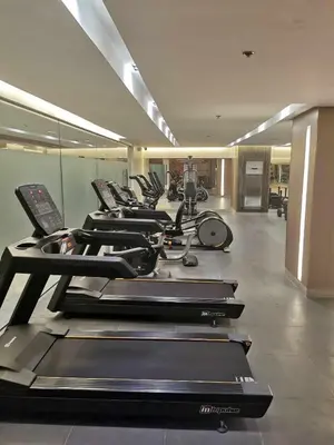 a row of treadmills in a gym with a row at Mao shore 3 residence tower 2 in Manila