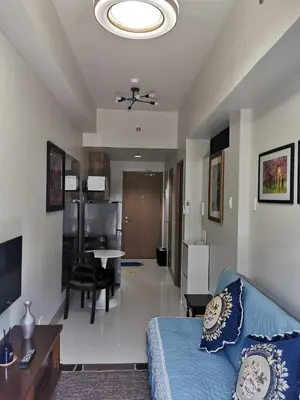 a living room with a couch and a dining room at Mao shore 3 residence tower 2 in Manila