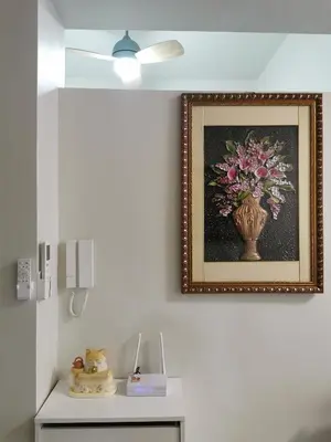 a picture of a vase of flowers on a wall at Shore 3 residence Moa Pasay in Manila