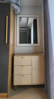 a mirror on top of a dresser in a bedroom at Perfect blend of home & comfort in Manila