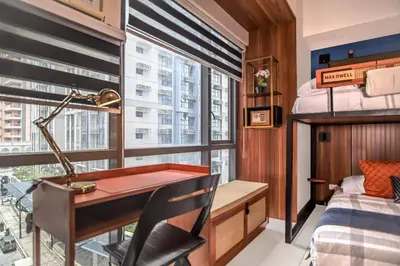 a bedroom with a desk and a bed and a window at 1Up Retreat at BGC, Cinema Style near Mall in Manila