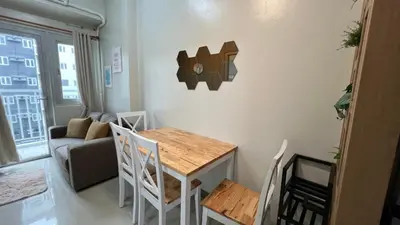 a small living room with a table and chairs at UrbanEase Living at Charm Residences Near Sta Lucia Mall and Robinsons Mall in Manila