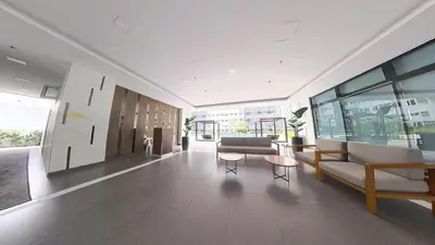 a lobby with a couch and chairs in a building at UrbanEase Living at Charm Residences Near Sta Lucia Mall and Robinsons Mall in Manila