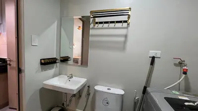 a bathroom with a sink and a toilet and a mirror at UrbanEase Living at Charm Residences Near Sta Lucia Mall and Robinsons Mall in Manila