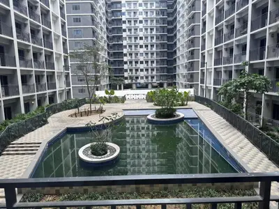 a pool in the middle of a building with buildings at Shore 2 Residences in Manila