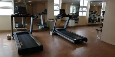 a gym with several exercise bikes in a room at 101 Newport Boulevard in Manila