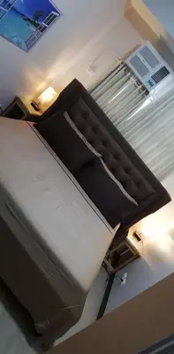a large bed in a room with at 101 Newport Boulevard in Manila
