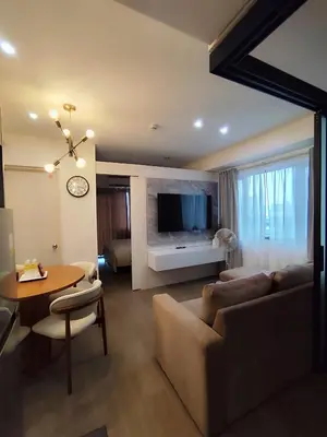 a living room with a couch and a table at Aya's Place Two Bedrooms near MOA in Manila