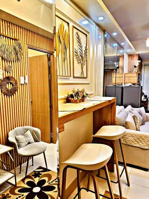 a room with a kitchen and a living room with a couch at Kendra Suite at Shore 3 Residences, MOA in Manila