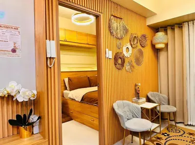 a bedroom with a bed and a table and chairs at Kendra Suite at Shore 3 Residences, MOA in Manila