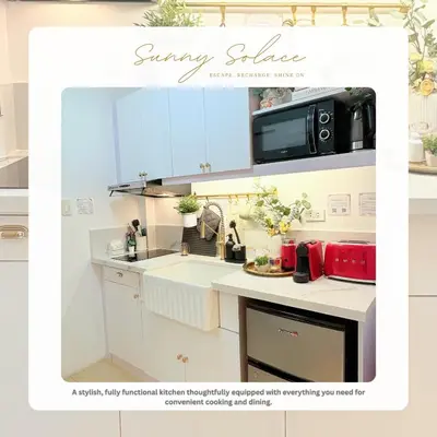 a kitchen with a sink and a microwave at Sunny Solace a Homey Condo in Filinvest Alabang in Manila