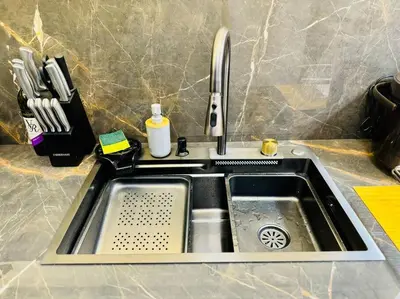 a stainless steel kitchen sink with a cutting board at La Prima - The Perfect Urban Oasis in Santa Rosa