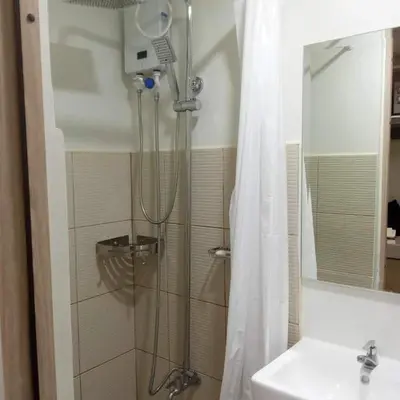 a bathroom with a shower and a sink at 1014 - Cavite Minimalist Condo with Resort-like Amenities & Hi Speed Wifi in Dasmariñas