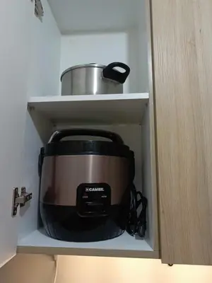 a slow cooker sitting inside of a cabinet at Shore 2 Residences high speed Internet walking distance to MOA and IKEA in Manila