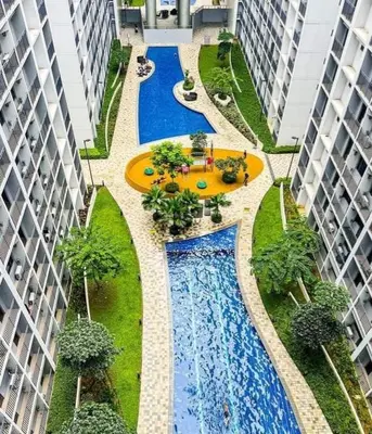 an overhead view of two swimming pools in a courtyard between two buildings at Shore 2 Residences high speed Internet walking distance to MOA and IKEA in Manila