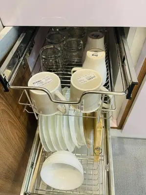 a refrigerator filled with white dishes in a drawer at Marias Suite near Manila bay FREE use of Pool in Manila