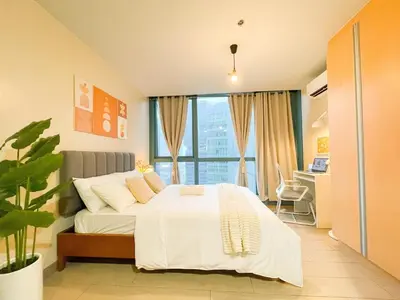 a bedroom with a white bed with a large window at Prime BGC Condo: Uptown Mall & Hyatt #ournw21n in Manila