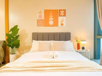 a bedroom with a bed with two towels on it at Prime BGC Condo: Uptown Mall & Hyatt #ournw21n in Manila