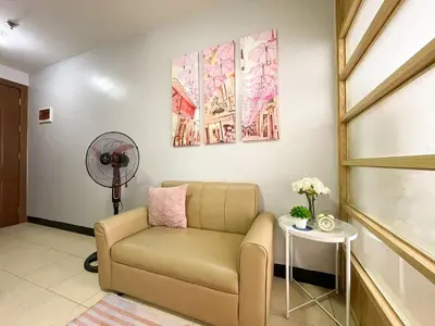 a living room with a couch and a table at Cozy & Affordable Stay Near Bgc #rt33005 in Manila