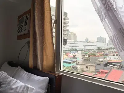 a bedroom window with a view of a city at Affordable Condo Near Bgc, Venice Mall #rt33006 in Manila