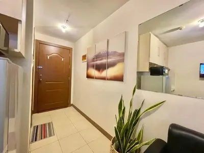 a hallway with a door and a plant in a room at Budget-friendly Condo Near Bgc, Venice #rt34008 in Manila