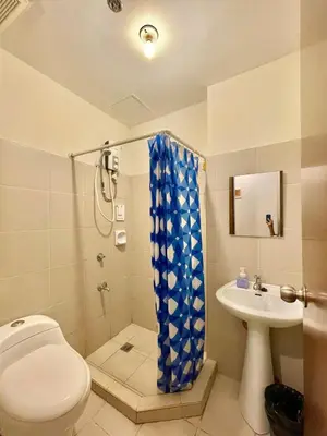 a bathroom with a toilet and a sink at Budget-friendly Condo Near Bgc, Venice #rt34008 in Manila