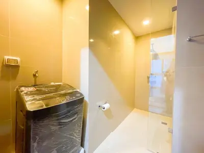 a bathroom with a shower with a glass door at Premium BGC 1BR Near Grand Hyatt #upt119h in Manila