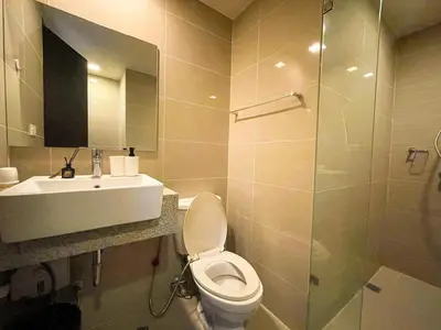 a bathroom with a toilet and a sink and a shower at BGC Condo Facing Mitsukoshi Mall #upt122g in Manila