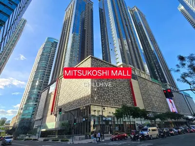 a building with a sign for a mitsubishi mall at Exclusive BGC Condo at Uptown Area #upt136d in Manila