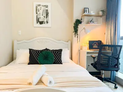 a bedroom with a bed with a desk and a chair at Upscale BGC Stay Near Mitsukoshi #upt130g in Manila
