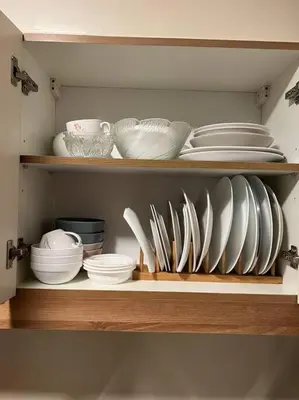 a shelf with plates and bowls and other dishes at 2-bedroom with Balcony in a Resort Setting - H Ivory in Manila