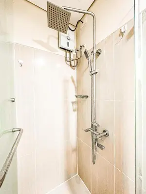a shower with a shower head in a bathroom at 633 Air Condo Pool View Escape Cozy 1BR w Sofa Bed in Manila
