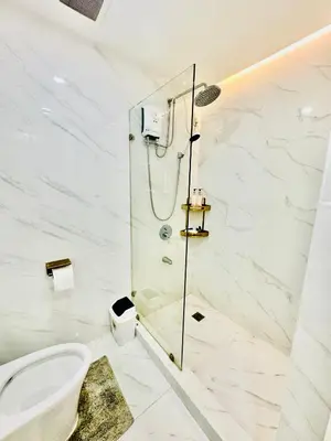 a bathroom with a shower and a toilet at Gina Staycation Condo Unit in Manila