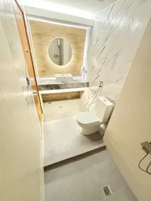 a bathroom with a toilet and a sink and a mirror at LA Amore Place Aspire Tower Nuvo City Libis in Manila
