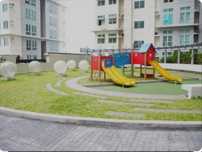 a playground with a slide in a park at The Quin Place 1BR 200Mbps WIFI in Manila
