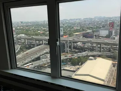 a view from a window of a city with traffic at The Quin Place 1BR 200Mbps WIFI in Manila