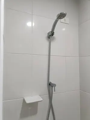 a shower with a shower head in a bathroom at Lorde's Hideaway in Manila