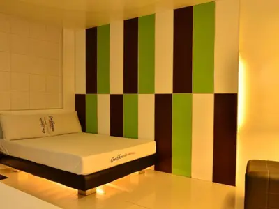 a room with a bed with a colorful wall at One Serenata Hotel General Trias in Rosario
