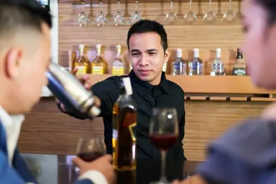 a man pouring a glass of wine at a bar at Vista Hotel Cubao in Manila