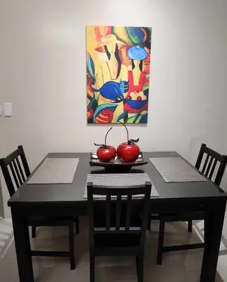 a black table with two chairs and two apples on it at 1 Bed Apartment - Sleeps 7 - Pool & Wifi in Manila