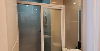 a bathroom with a shower and a toilet at 1 Bed Apartment - Sleeps 7 - Pool & Wifi in Manila
