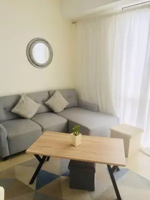 a living room with a couch and a coffee table at Lovely two bedroom apartment with balconies in Manila