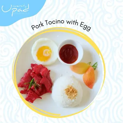 a plate of food with an egg and rice at UPad Hotel in Manila