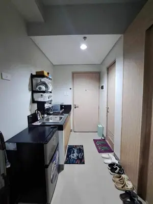 a kitchen with shoes lined up on the floor at Apartment Condo Unit in Rizal in Manila