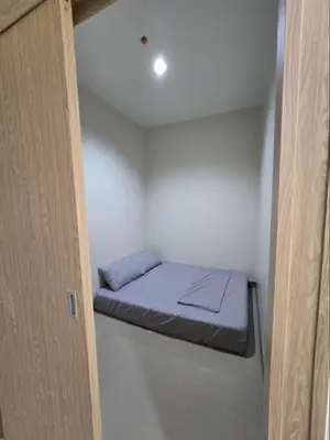 a small room with a small bed in the ceiling at Apartment Condo Unit in Rizal in Manila