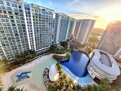an aerial view of a large building with a swimming pool at Masies Beach View Suite at Azure Urban Resort Residences in Manila