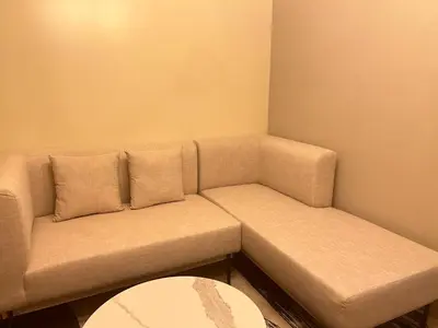 a living room with a couch and a table at One Uptown Residences BGC in Manila